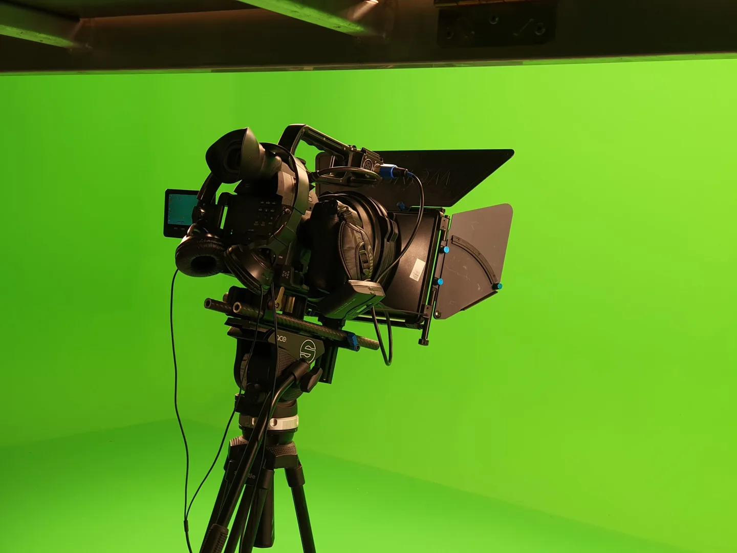 Caméra et prompteur devant un fond vert
